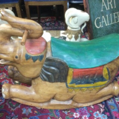 A reproduction carved wooden child's rocking horse in the form of an elephant, approx length 70cm. Shipping category D.
