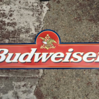 A vintage Budweiser embossed advertising sign , 117cm long x38cm tall
