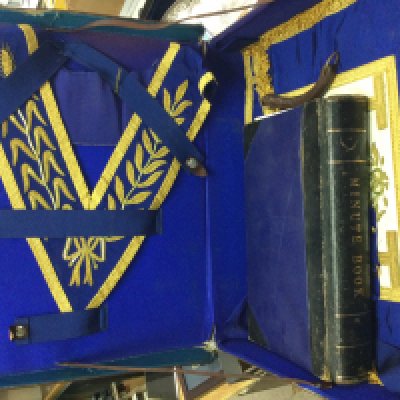 A leather case containing Masonic items including a Minute book. This lot cannot be posted