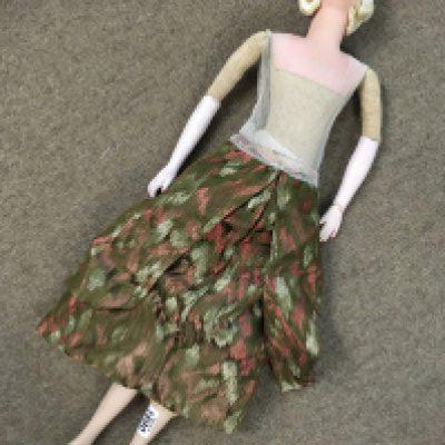 A large 1950's doll. Damage to left wrist