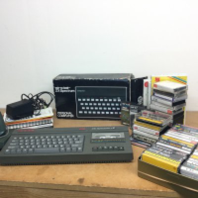 A boxed vintage Sinclair ZX spectrum PC and a Sinclair 128k ZX Spectrum +2 and games, additional games and joystick, manual . Postage category C