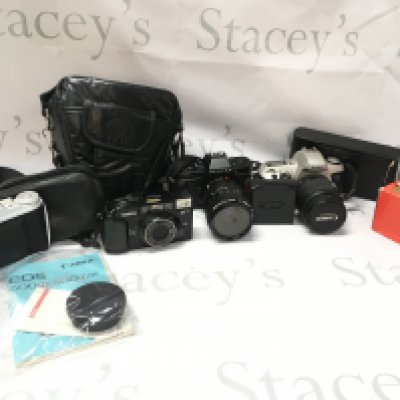 A box of vintage cameras including Agfa Isolette I, Konica MT-9, Pentax P30N, Canon EOS 500N, Kodak Easyshare CX6200