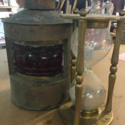 A time glass together with a ships lamp .