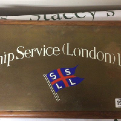An enamel decorated brass plaque Ship Service London. 25x46cm