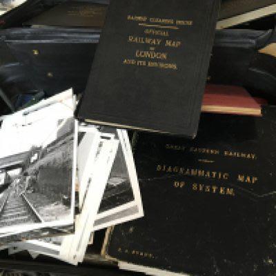 A case containing British Rail and British train memorabilia including Press photos a Vintage folding information diagram Great Eastern Railways Railway Clearing House Railway maps London East of England Scotland and many other related ephemera.