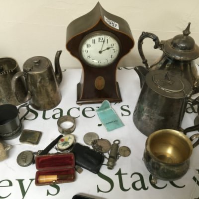 An Edwardian inlaid Mahogany clock a quantity of silver plate silver napkin rings and other oddments.
