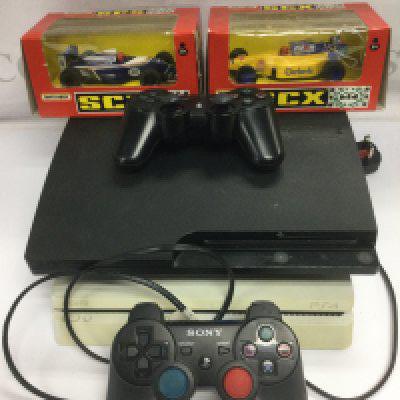A Playstation PS3 and a PS4 with two controllers and two boxed Scalextric F1 cars.