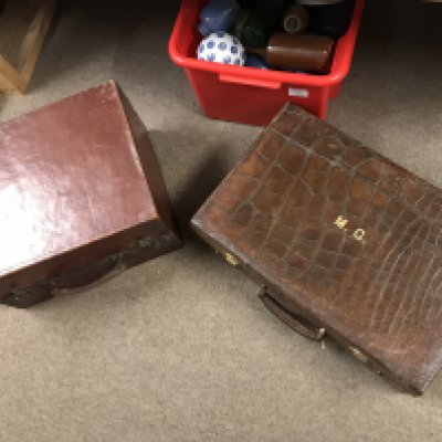 A leather case and a crocodile case, postage category C