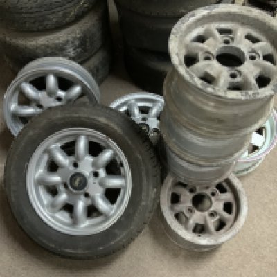 Vintage Mini Cooper parts. 4 Alloy wheels 28cm diameter, 1 Enamelled steel wheel 33cm diameter, 3 alloy wheels 33cm diameter.