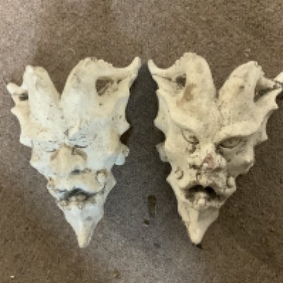 A pair of plaster Devil wall masks