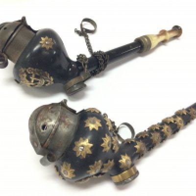 Two small Victorian smoking pipes, one decorated with brass stars and the other a small brass cow . 14 and 11cm long. Postage category A