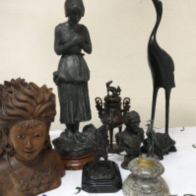A collection of bronze and metal figures including a Spelter figure reflecting the Irish Potato famine 1845-52. Also Chinese bronze and a pair of carved Malaysian hardwood busts with glass eyes.