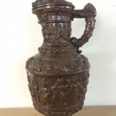 A German pottery ewer, Metilach style decorated with classical style figures and animals. 53cm tall approximately .This lot cannot be posted- NO RESERVE
