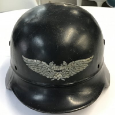 A German Third Reich Luftschutz fire helmet with no lining. With stamped EF64 and 675.
