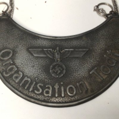 A rare German Gorget: a WW2 NAZI 'TODT' ORGANISATION Gorget. Crescent moon shape with blue felt backing & hanging loops later chain. Vendors comments found in Jersey.