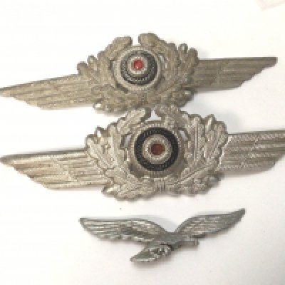 Two German Third Reich Luftwaffe peaked cap officers Insignia one other conforming badge. (3)