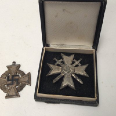 A German Third Reich war merit cross first class in a fitted box pin stamped LM6 with further small symbol. and a 25year long service cross