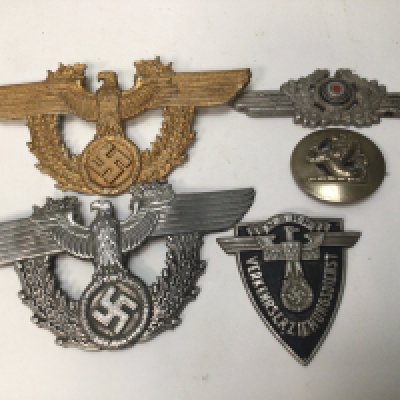 Two German Third Reich Police Shako Plates.Worn on the Nazi police helmet , the gold coloured example still w with both of its screwed fixing pins on the reverse side one other silver finish and Luftwaffe cap plate and two other badges.