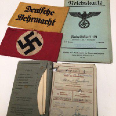 A German ID book dated 1939 two German Nazi party Arm bands and a German Third Reich map.
