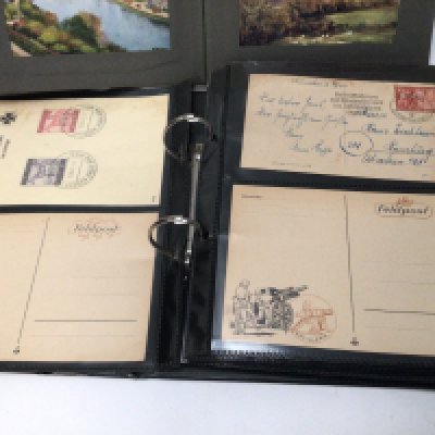 Three albums containing post cards including German Third Reich postcards and other world cards.
