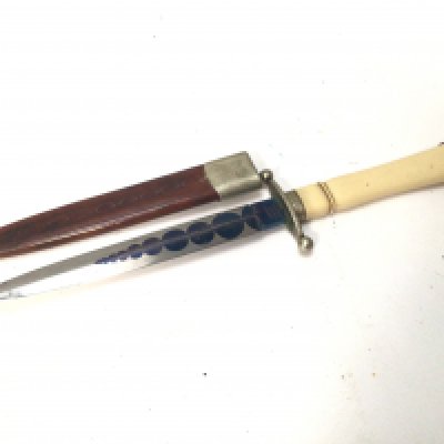 An unusual Presentation dagger the blade with a graduating blued circle pattern maker woodhead Sheffield. With a leather scabbard length 31cm
