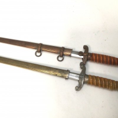 Two German II world war Third Reich military officers presentation daggers oth with makers names to the blades one with a copper finish on with damage (2)