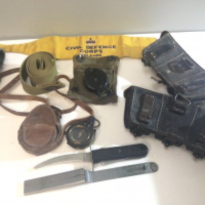 A Military Compass belonging to Captain W J Hepburn The Royal Scots an American II world war compass belts a Sheffield multi purpose knife military issue ammunition pouches and other oddments.