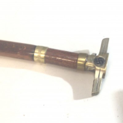 A Walking stick the top with shaped metal end and stamped marks see images.