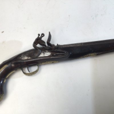 A French 18th century flintlock lock pistol maker Dumarest with brass mounts and ornamented cast barrel with applied gold decoration.