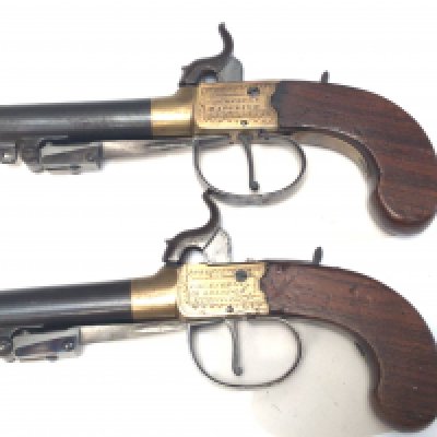 Two matching Percussion 19th century pistols with flick bayonet sliding trigger guard brass slab sided action engraved with makers name Cocksedge Hadleigh twist of steel barrel with proof marks. (2)