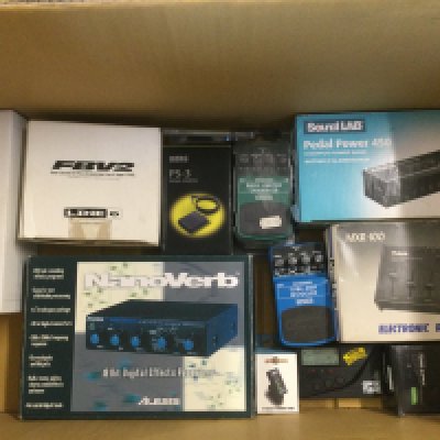 A box of effects pedals comprising an Alesis Nanoverb, various Behringer pedals etc.