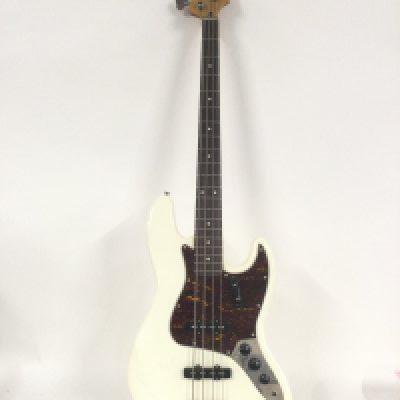 A Fender Squier Jazz bass guitar in white with a tortoishell pickguard. Comes supplied with a hard carry case.