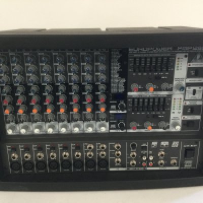 A boxed Behringer PMP-1280S 1,200W powered mixer with dual multi fx processor.