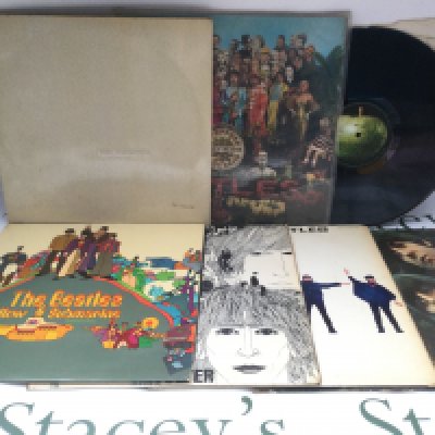 Seven early pressings of Beatles LPs comprising a numbered 'White Album' 0461794 and complete with all inserts, 'Sgt Pepper', a mono 'Revolver' and others. 'Abbey Road' is lacking it's cover.