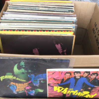A box of LPs and 12" singles by various artists including