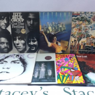 Two bags containing 23 promo copy LPs and 12" singles by various artists including Marc Bolan, Meat Loaf, Jeff Beck Group, Abba and others.