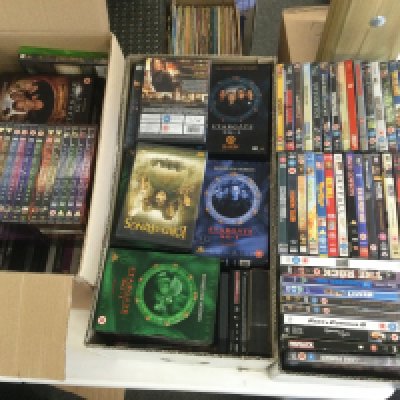 Three boxes of DVDs and BluRays.