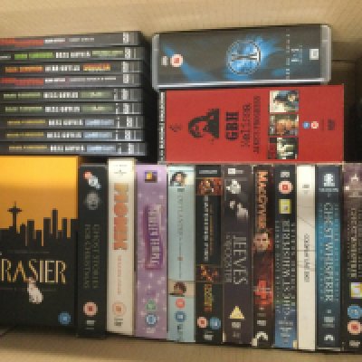 Four boxes of DVDs and CDs including various box sets.