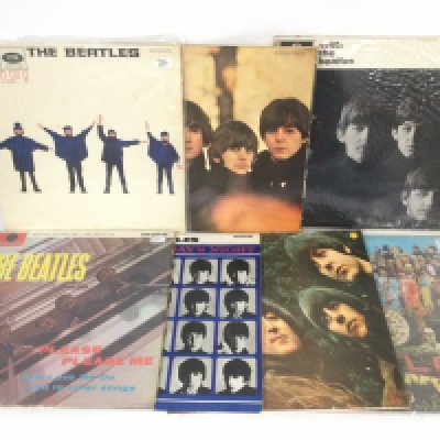 Fifteen Beatles LPs including 'Please Please Me' (black and yellow labels), 'Rubber Soul', 'Sgt Pepper' and others.
