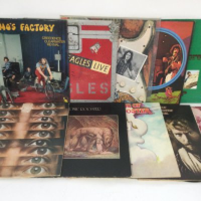 Two bags containing 20 rock and pop LPs by various artists including Atomic Rooster, Rory Gallagher, Creedence Clearwater Revival and others.