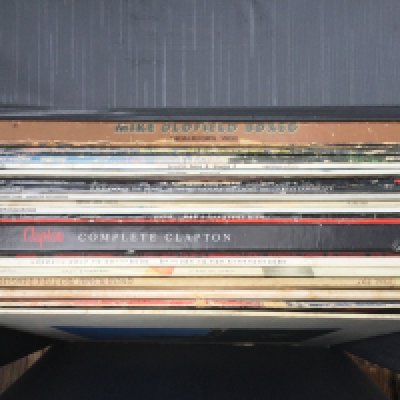 A record case of LPs by various artists including The Beatles, David Bowie, Pink Floyd and others.