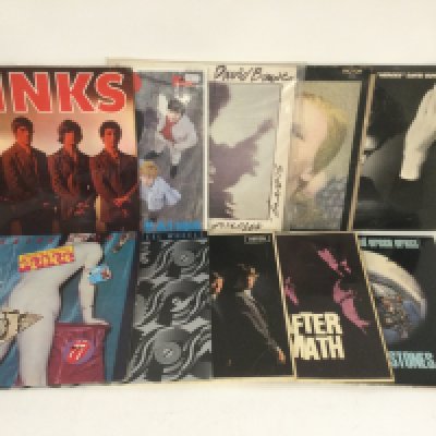 Two bags containing 20 rock LPs by various artists including David Bowie, The Rolling Stones, Queen and others. Includes a yellow vinyl 'Goodbye Yellow Brick Road'.