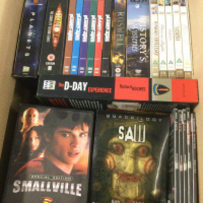 Four boxes of DVDs and VHS tapes comprising various films and TV series including some box sets.