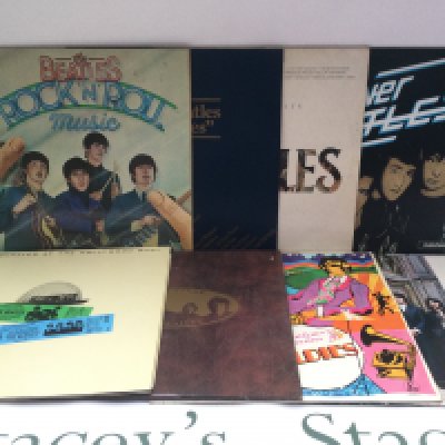 A record case of Beatles and LPs comprising mainly compilations including 'Rock n Roll Music', 'Hey Jude', 'At The Hollywood Bowl' and others.