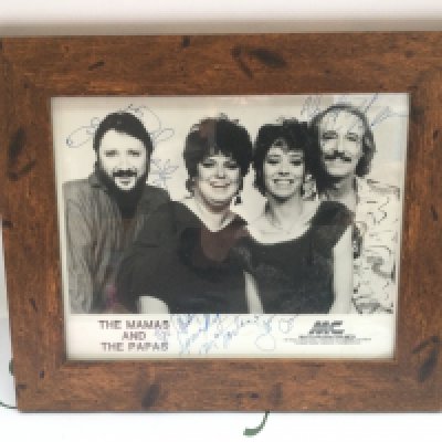 A framed and glazed signed The Mamas And The Papas publicity card, approx 32cm x 27cm.