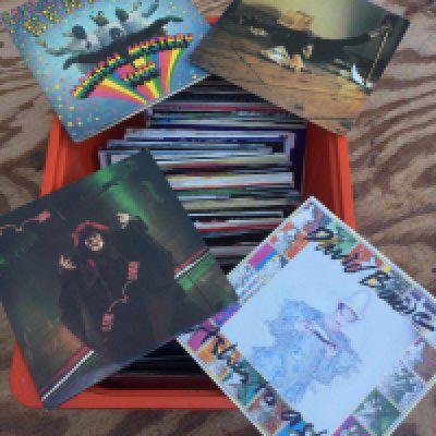 A box of 7" singles and EPs by various artists including The Beatles, David Bowie, Kate Bush and many more.