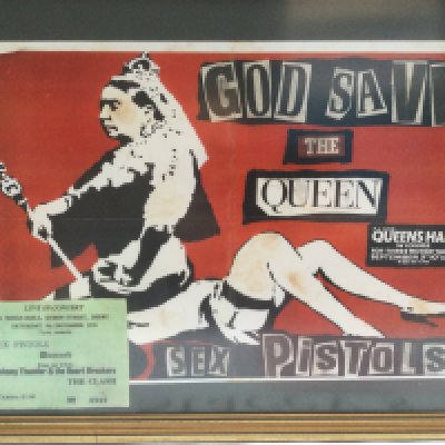 A reproduction Sex Pistols concert ticket for a 1976 tour where most dates were cancelled, a reproduction concert poster plus a framed and glazed display of a Pretty Vacant 7" single and monochrome print of the original line up.
