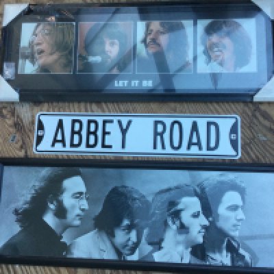 A collection of Beatles posters including an Abbey Road tin sign, framed postcards etc.