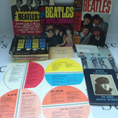 A collection of Beatles ephemera including a 1964 copy of In His Own Write, scrapbook, poster, various books, magazines etc.