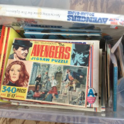 Two boxes of items relating to the The Avengers TV series comprising books, magazines, jigsaws etc.